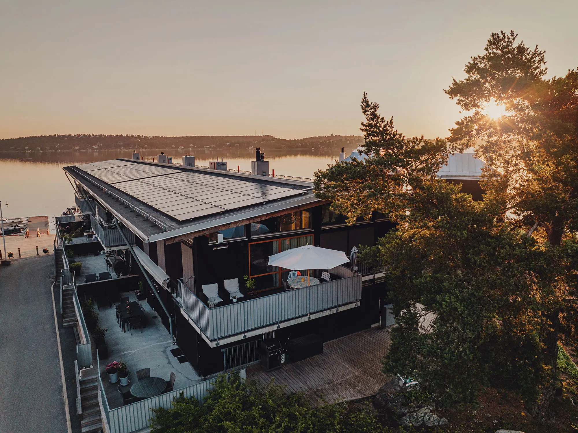 Hus vid vatten med solpaneler